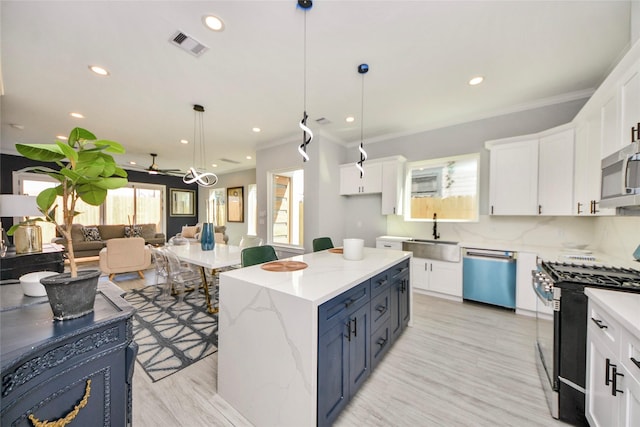 3033 Dennis St, Houston, TX 77004 - kitchen featuring appliances with stainless steel finishes, a sink, white cabinetry, recessed lighting, and ornamental molding