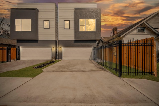 3033 Dennis St, Houston, TX 77004 - view of front of home featuring stucco siding, an attached garage, driveway, and fence