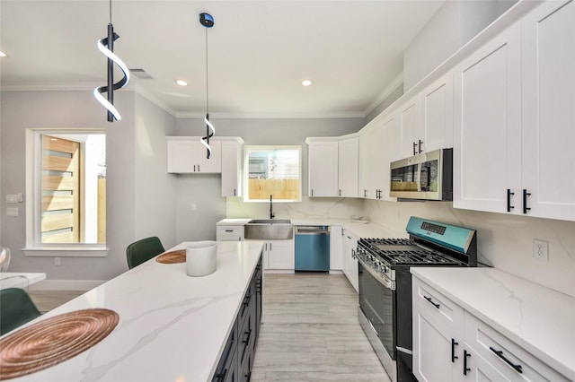 3033 Dennis St, Houston, TX 77004 - kitchen with appliances with stainless steel finishes, a sink, white cabinets, ornamental molding, and recessed lighting