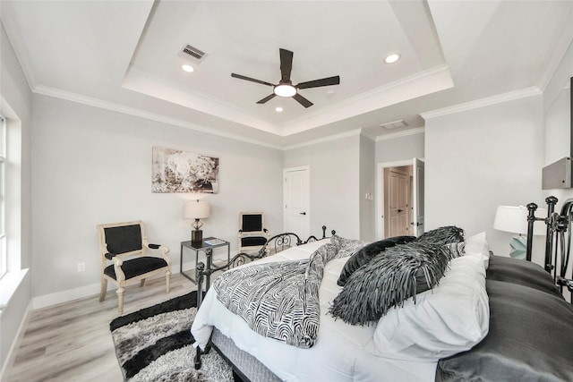3033 Dennis St, Houston, TX 77004 - bedroom featuring light wood-style floors, a raised ceiling, recessed lighting, ornamental molding, and baseboards