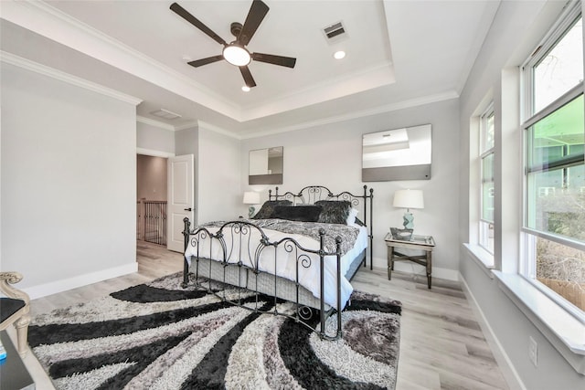 3033 Dennis St, Houston, TX 77004 - bedroom featuring light wood-style floors, a raised ceiling, baseboards, crown molding, and ceiling fan