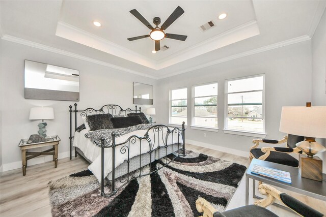 3033 Dennis St, Houston, TX 77004 - bedroom with wood finished floors, a tray ceiling, ornamental molding, baseboards, and recessed lighting