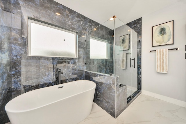 3033 Dennis St, Houston, TX 77004 - bathroom with marble tiled floors, a stall shower, a freestanding tub, and baseboards