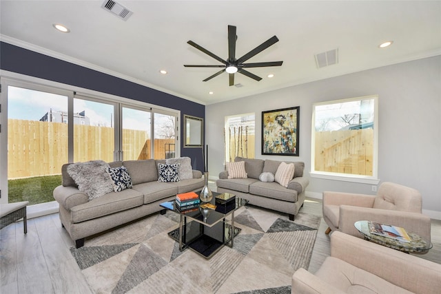 3033 Dennis St, Houston, TX 77004 - living area featuring wood finished floors, a ceiling fan, recessed lighting, baseboards, and crown molding