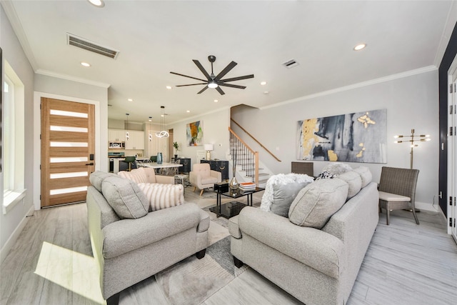3033 Dennis St, Houston, TX 77004 - living area with stairs, baseboards, light wood-type flooring, recessed lighting, and ornamental molding