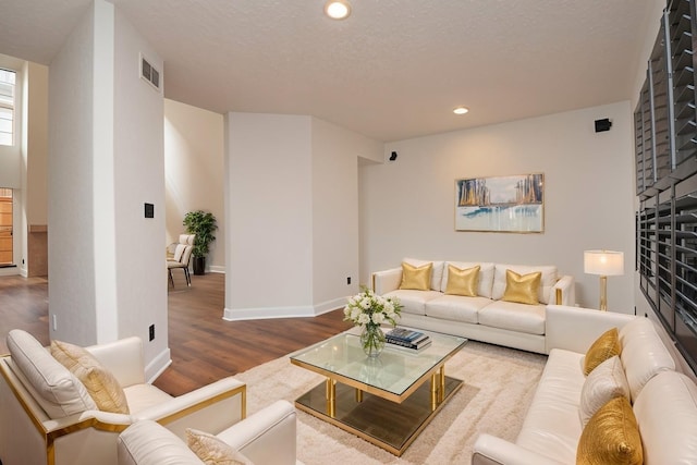 1425 Nantucket Dr Unit D, Houston, TX 77057 - living area featuring wood finished floors, recessed lighting, baseboards, and a textured ceiling