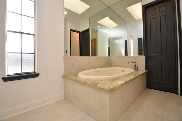 1425 Nantucket Dr Unit D, Houston, TX 77057 - bathroom featuring a skylight, tile patterned flooring, a garden tub, and baseboards