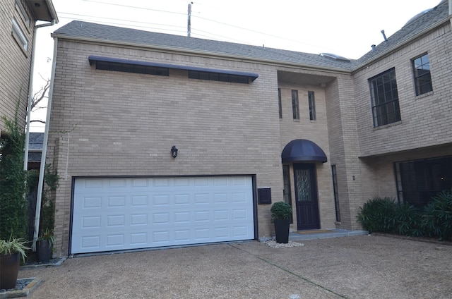 1425 Nantucket Dr Unit D, Houston, TX 77057 - view of front of home with asphalt driveway, brick siding, and a garage