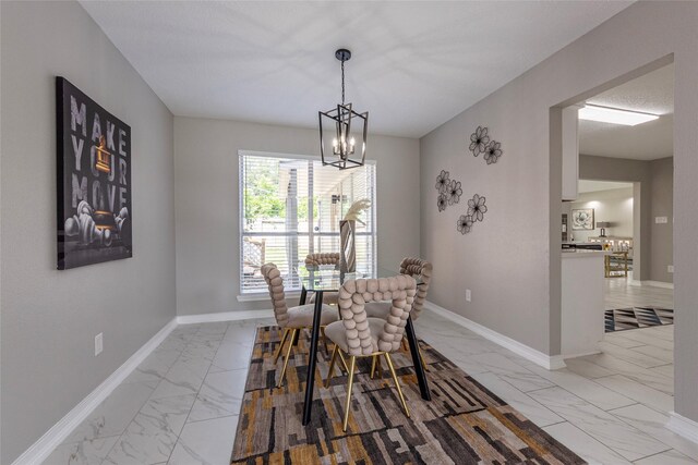 2720 Hot Springs Dr, Pearland, TX 77584 - dining space featuring light marble finish floors, a chandelier, and baseboards