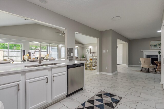 2720 Hot Springs Dr, Pearland, TX 77584 - kitchen with stainless steel dishwasher, a sink, lofted ceiling, light marble finish floors, and white cabinetry