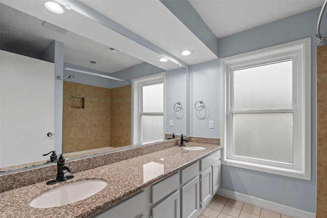7611 Creekfield Dr, Spring, TX 77379 - full bathroom with tile patterned flooring, double vanity, baseboards, and recessed lighting