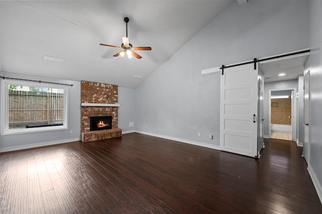 7611 Creekfield Dr, Spring, TX 77379 - unfurnished living room with ceiling fan, a barn door, hardwood / wood-style floors, high vaulted ceiling, and baseboards