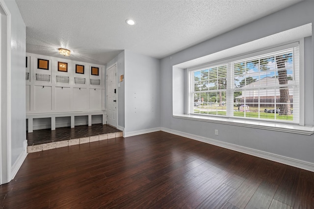 7611 Creekfield Dr, Spring, TX 77379 - mudroom with a textured ceiling, dark wood-style flooring, and baseboards