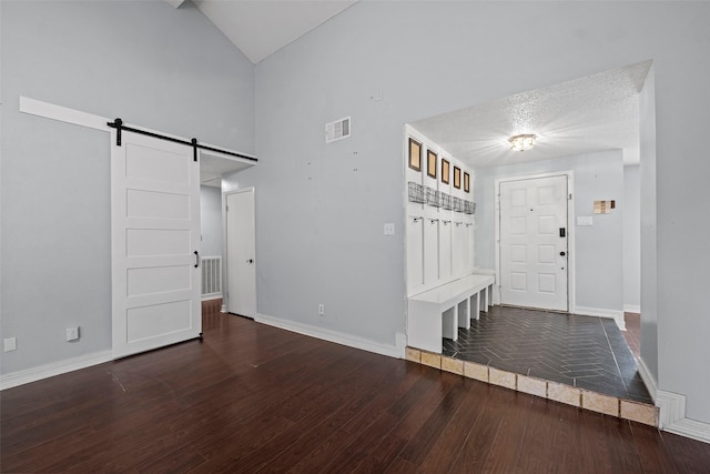 7611 Creekfield Dr, Spring, TX 77379 - entryway featuring a barn door, baseboards, wood finished floors, and high vaulted ceiling
