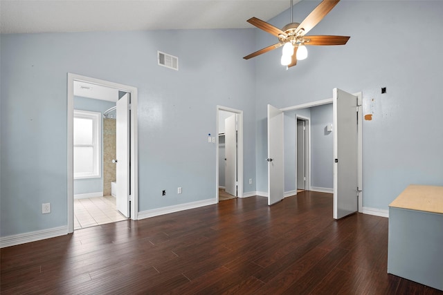 7611 Creekfield Dr, Spring, TX 77379 - unfurnished living room with high vaulted ceiling, ceiling fan, wood finished floors, and baseboards
