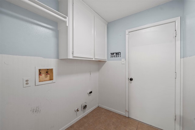 7611 Creekfield Dr, Spring, TX 77379 - clothes washing area featuring cabinet space, electric dryer hookup, hookup for a washing machine, light tile patterned floors, and a wainscoted wall