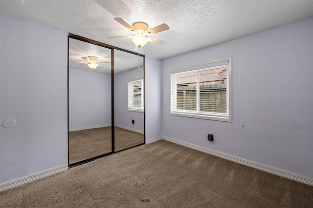 7611 Creekfield Dr, Spring, TX 77379 - unfurnished bedroom featuring carpet, a textured ceiling, a closet, a ceiling fan, and baseboards