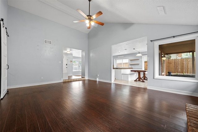 7611 Creekfield Dr, Spring, TX 77379 - unfurnished living room with a ceiling fan, wood finished floors, high vaulted ceiling, a barn door, and baseboards