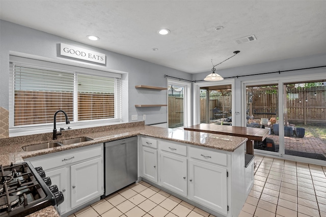 7611 Creekfield Dr, Spring, TX 77379 - kitchen with a sink, stainless steel dishwasher, a peninsula, white cabinetry, and recessed lighting