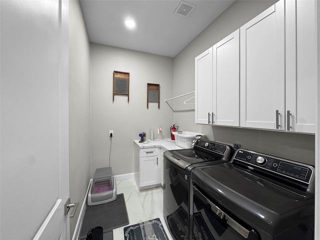 clothes washing area with light marble finish floors, cabinet space, washer and clothes dryer, and baseboards