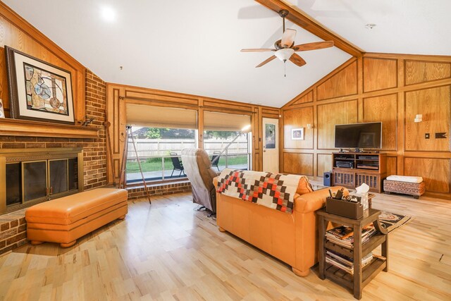 16135 Spinnaker Dr, Crosby, TX 77532 - living room featuring light wood finished floors, ceiling fan, wood walls, and a fireplace