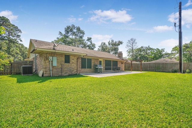 16135 Spinnaker Dr, Crosby, TX 77532 - rear view of property with central AC, a patio area, a chimney, brick siding, and roof with shingles