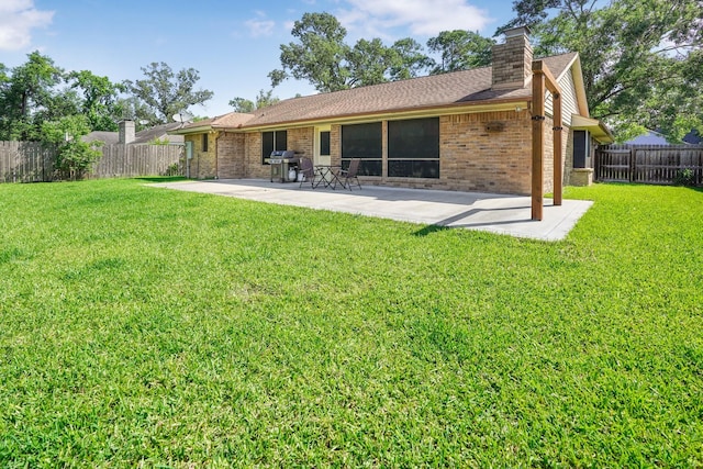 16135 Spinnaker Dr, Crosby, TX 77532 - back of house with brick siding, a patio, and a chimney