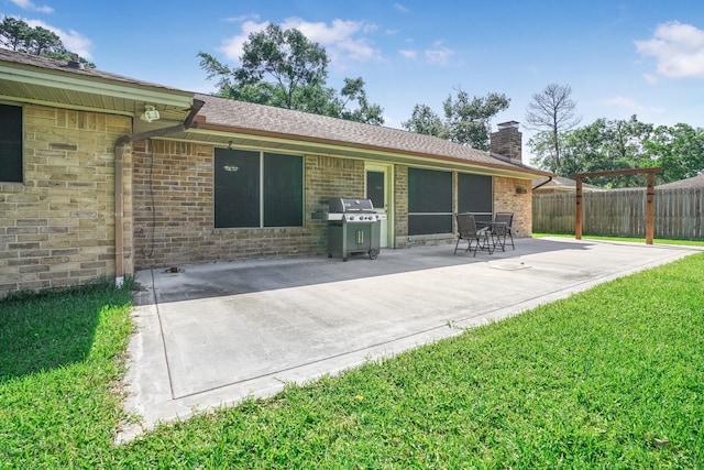 16135 Spinnaker Dr, Crosby, TX 77532 - back of house featuring a patio area, a chimney, and brick siding