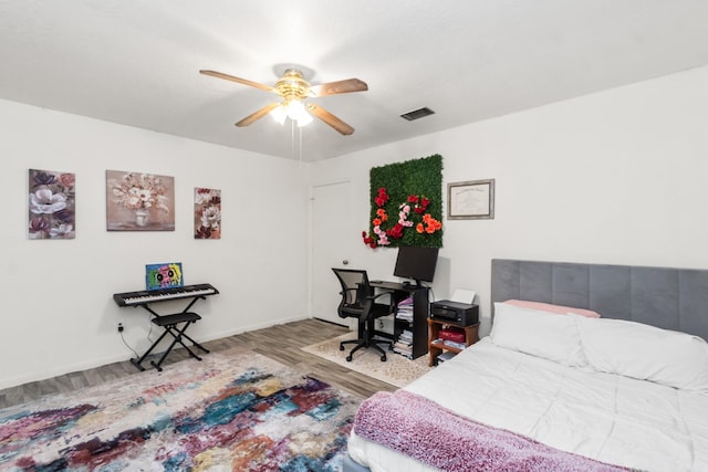 535 Oyster Creek Dr, Richwood, TX 77531 - bedroom with wood finished floors, a ceiling fan, and baseboards