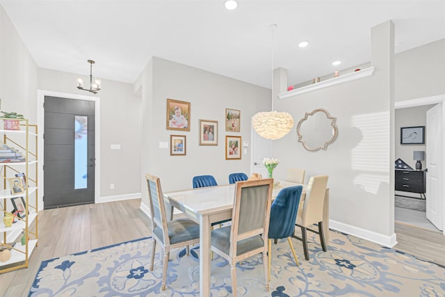 10702 Pleasant View Dr, Missouri City, TX 77459 - dining space with wood finished floors, a chandelier, baseboards, and recessed lighting
