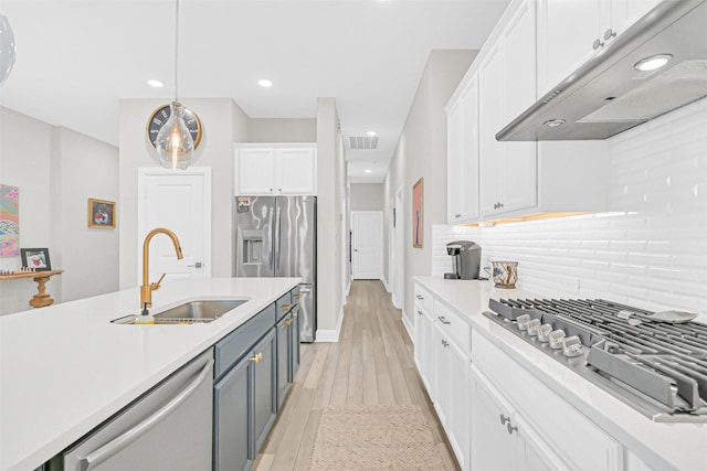 10702 Pleasant View Dr, Missouri City, TX 77459 - kitchen featuring a sink, appliances with stainless steel finishes, under cabinet range hood, white cabinets, and light countertops