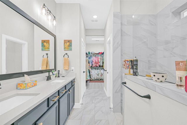 10702 Pleasant View Dr, Missouri City, TX 77459 - full bath with marble look tiles, baseboards, double vanity, and a spacious closet