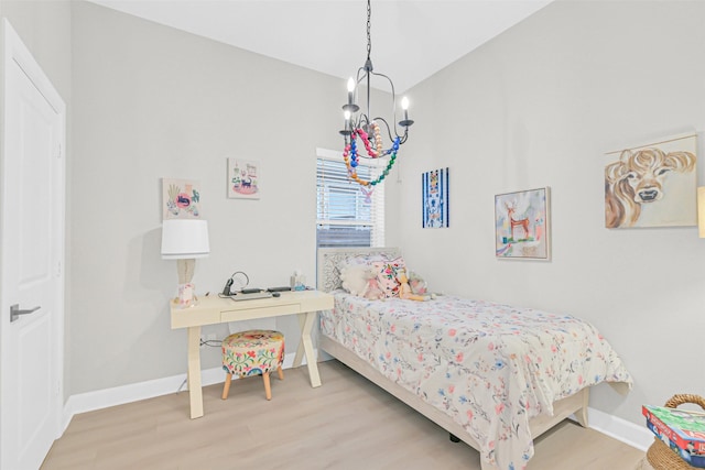 10702 Pleasant View Dr, Missouri City, TX 77459 - bedroom featuring a chandelier, wood finished floors, and baseboards