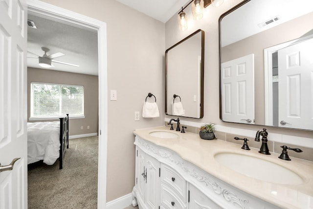 1140 Bartlett Rd, Katy, TX 77493 - bathroom featuring double vanity, baseboards, ensuite bathroom, and a ceiling fan