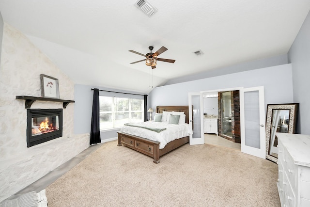 1140 Bartlett Rd, Katy, TX 77493 - carpeted bedroom featuring lofted ceiling, a stone fireplace, ceiling fan, and ensuite bath