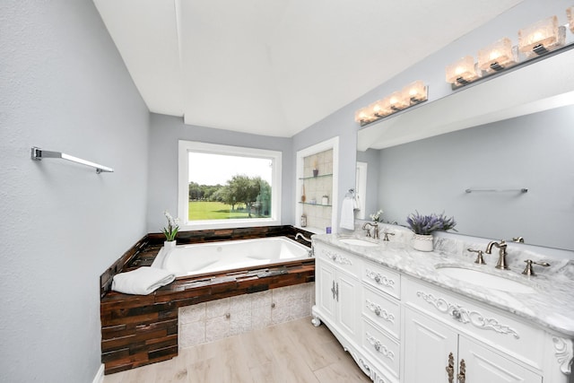 1140 Bartlett Rd, Katy, TX 77493 - bathroom featuring a bath, double vanity, wood finished floors, and tiled shower