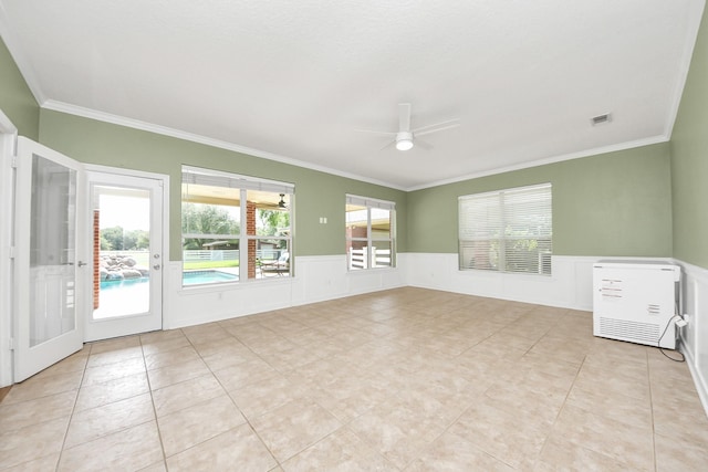1140 Bartlett Rd, Katy, TX 77493 - empty room with ornamental molding, ceiling fan, a wainscoted wall, and light tile patterned flooring