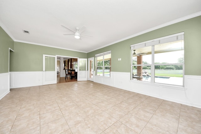 1140 Bartlett Rd, Katy, TX 77493 - unfurnished room featuring a ceiling fan, a decorative wall, wainscoting, crown molding, and light tile patterned floors