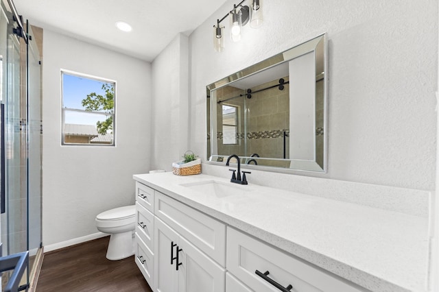 13430 Orleans St, Houston, TX 77015 - bathroom with vanity, toilet, a stall shower, wood finished floors, and baseboards