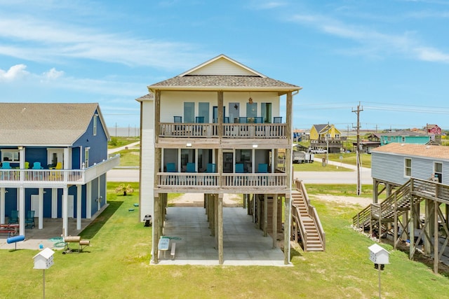 2176 Hwy 87, Gilchrist, TX 77617 - rear view of house with a carport, stairway, a patio, a balcony, and a yard