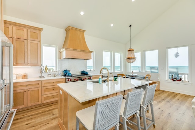 2176 Hwy 87, Gilchrist, TX 77617 - kitchen featuring premium range hood, light brown cabinets, light wood finished floors, range, and recessed lighting