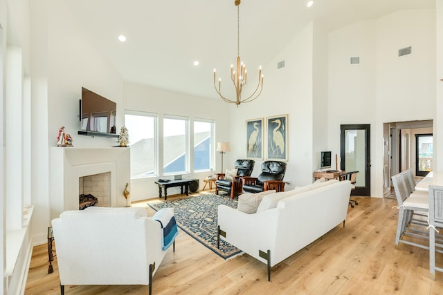 2176 Hwy 87, Gilchrist, TX 77617 - living room with a chandelier, high vaulted ceiling, light wood finished floors, recessed lighting, and a fireplace