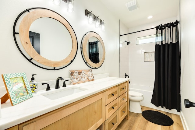 2176 Hwy 87, Gilchrist, TX 77617 - bathroom featuring vanity, wood finished floors, shower / tub combo with curtain, and toilet