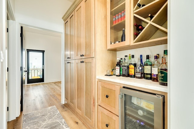2176 Hwy 87, Gilchrist, TX 77617 - indoor dry bar with wine cooler, light wood-style flooring, and baseboards