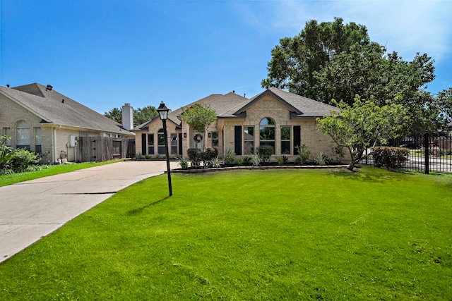 french provincial home with brick siding and a shingled roof