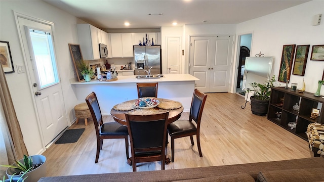 20822 Masella Ridge Dr, New Caney, TX 77357 - dining area featuring light wood-type flooring and recessed lighting