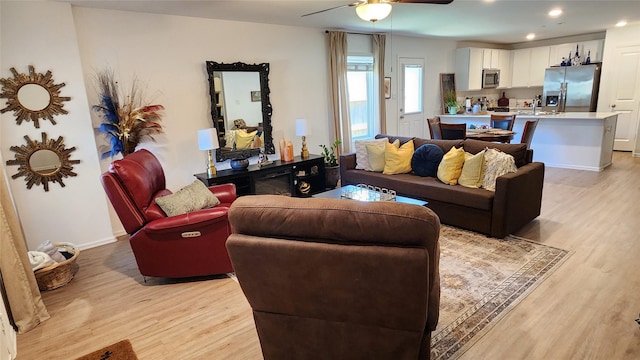 20822 Masella Ridge Dr, New Caney, TX 77357 - living area featuring light wood finished floors, ceiling fan, recessed lighting, and baseboards