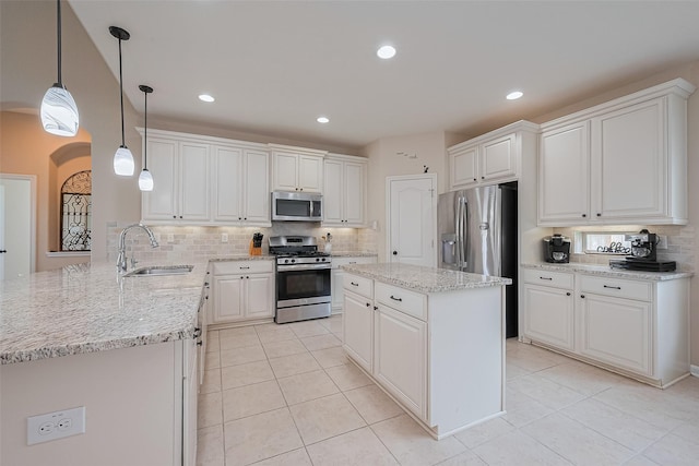 16747 Highland Country Dr, Cypress, TX 77433 - kitchen with appliances with stainless steel finishes, decorative backsplash, light tile patterned flooring, a peninsula, and recessed lighting