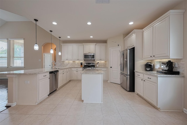 16747 Highland Country Dr, Cypress, TX 77433 - kitchen with stainless steel appliances, a peninsula, backsplash, white cabinets, and recessed lighting