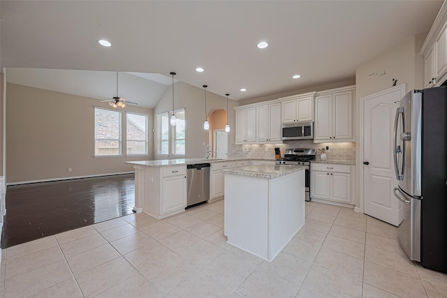 16747 Highland Country Dr, Cypress, TX 77433 - kitchen with stainless steel appliances, a peninsula, ceiling fan, backsplash, and white cabinets